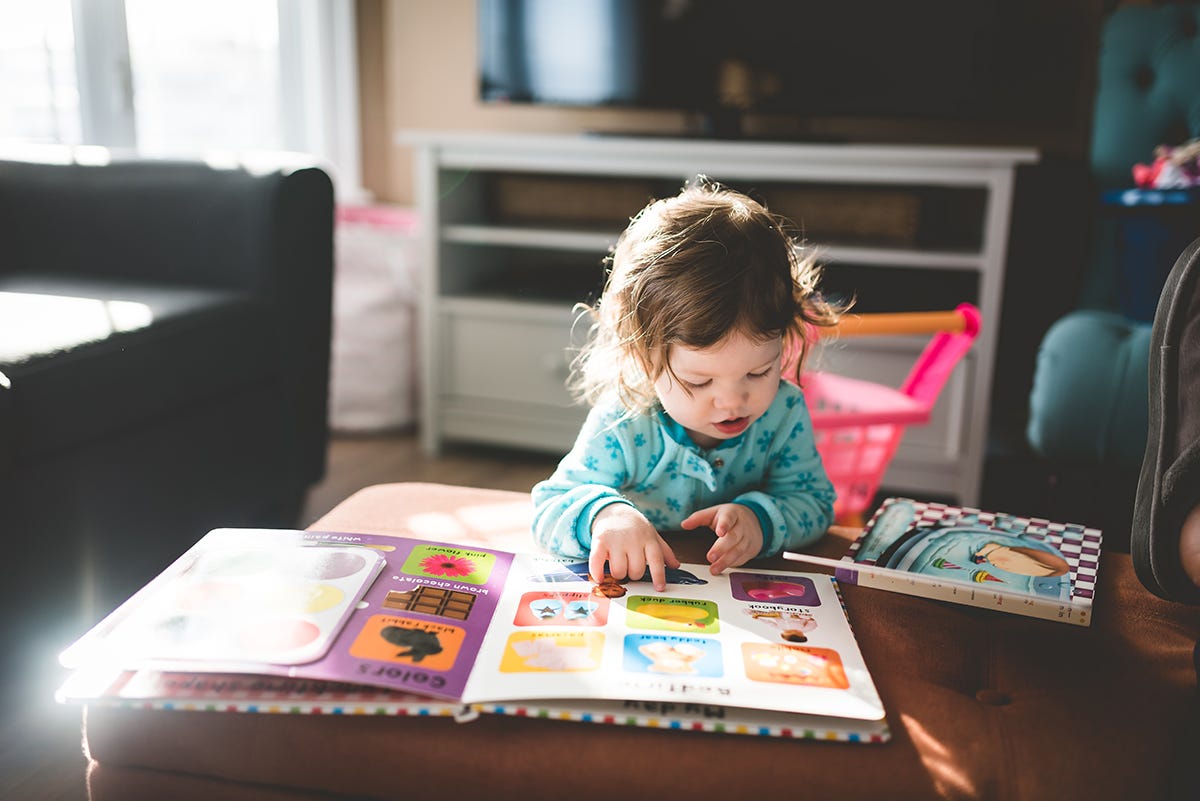 A child reading a book unassisted