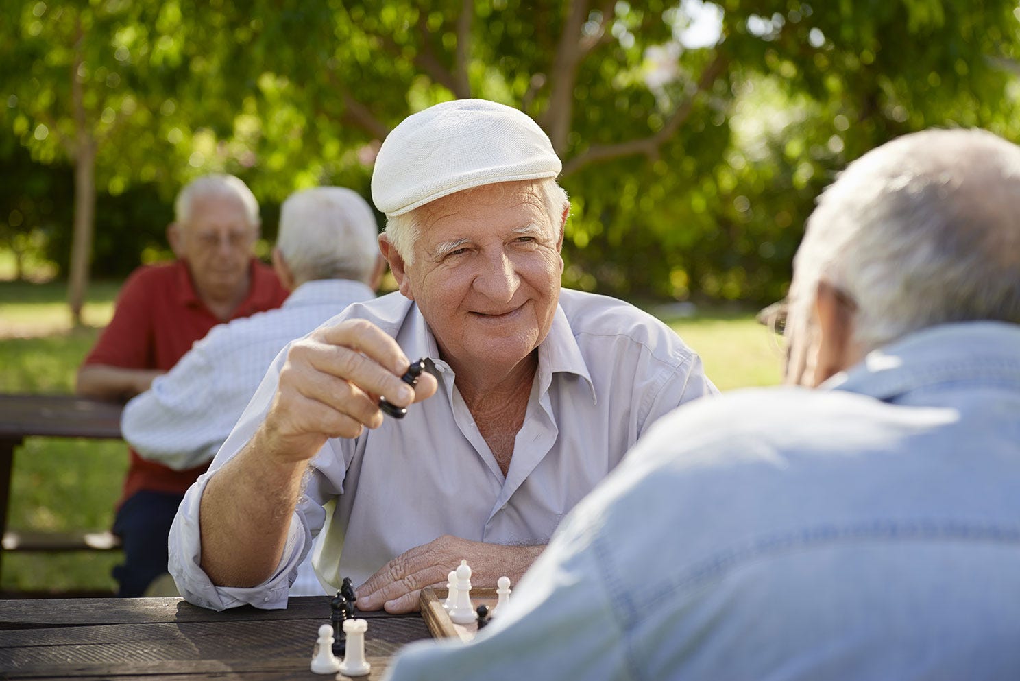 Senior men playing chess outside