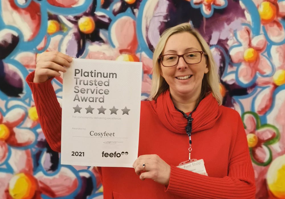 Adele holding the 2021 Feefo certificate