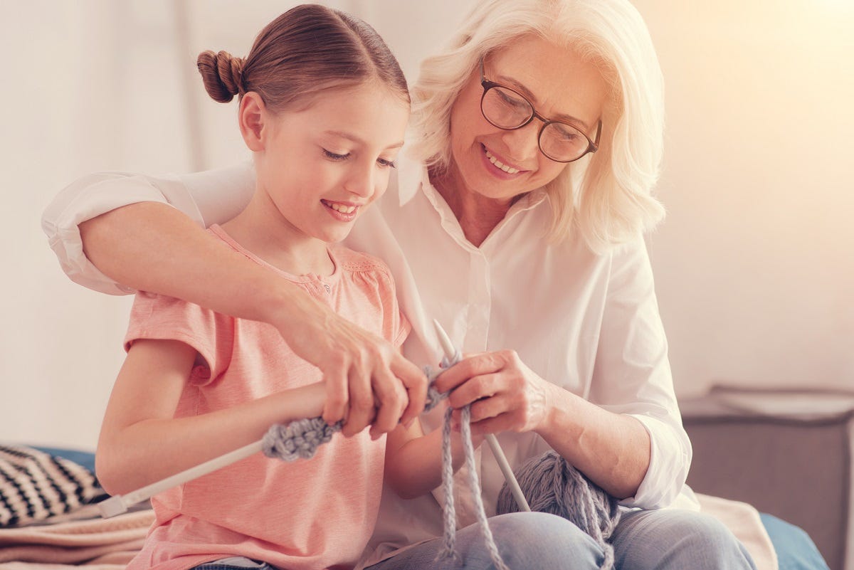 Grandparent knitting with grandchild