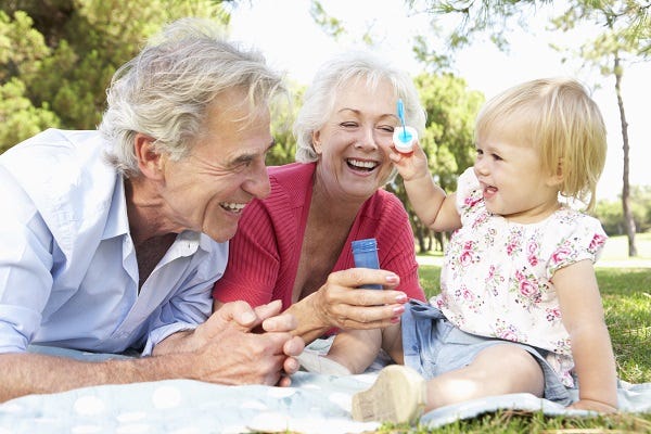 Grandparents outdoors with grandchild