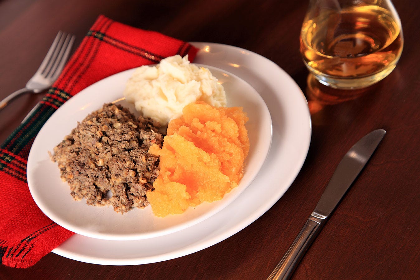 Dinner of haggis served with neeps, tatties and whiskey