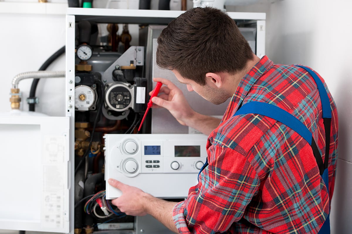 Plumber servicing a boiler