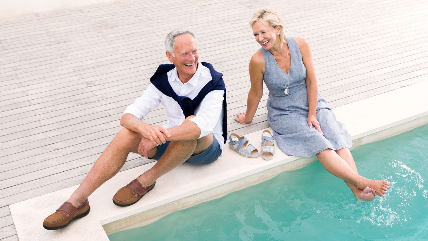 Couple relaxing by pool