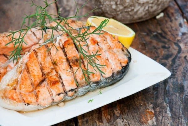 Grilled salmon steak with mustard dill sauce