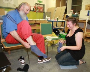 A guest receiving a new pair of socks at Crisis at Christmas